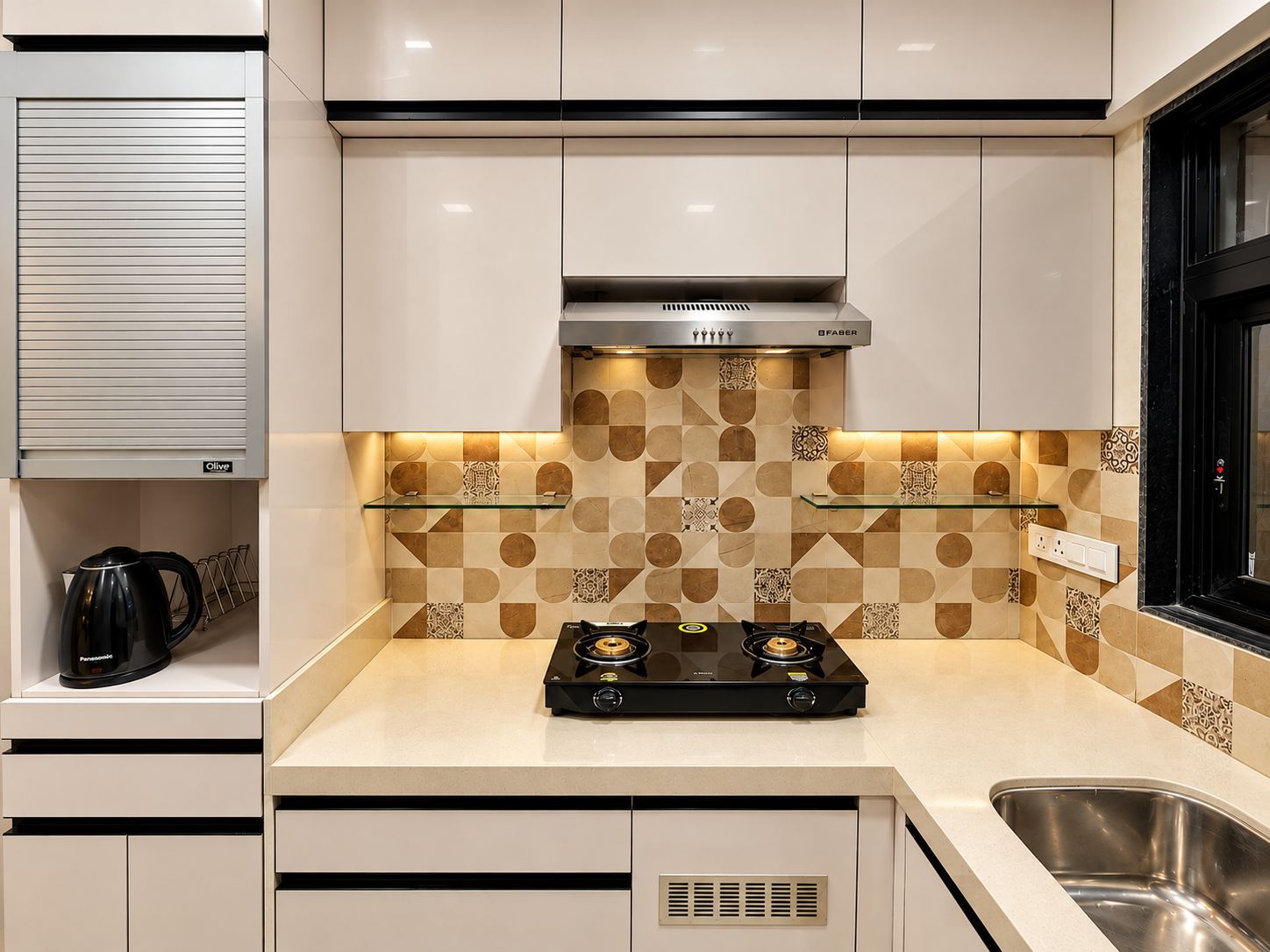 Ivory gloss kitchen with a geometric tile backsplash and a rolling-shutter appliance cabinet