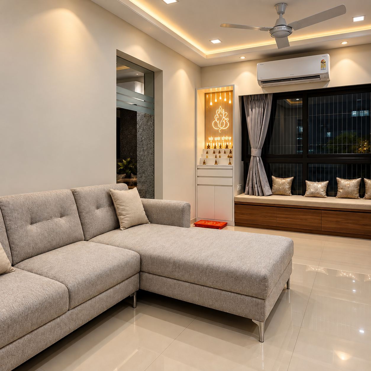 Living room with an L-shaped sofa, a storage window seat and a backlit mandir niche