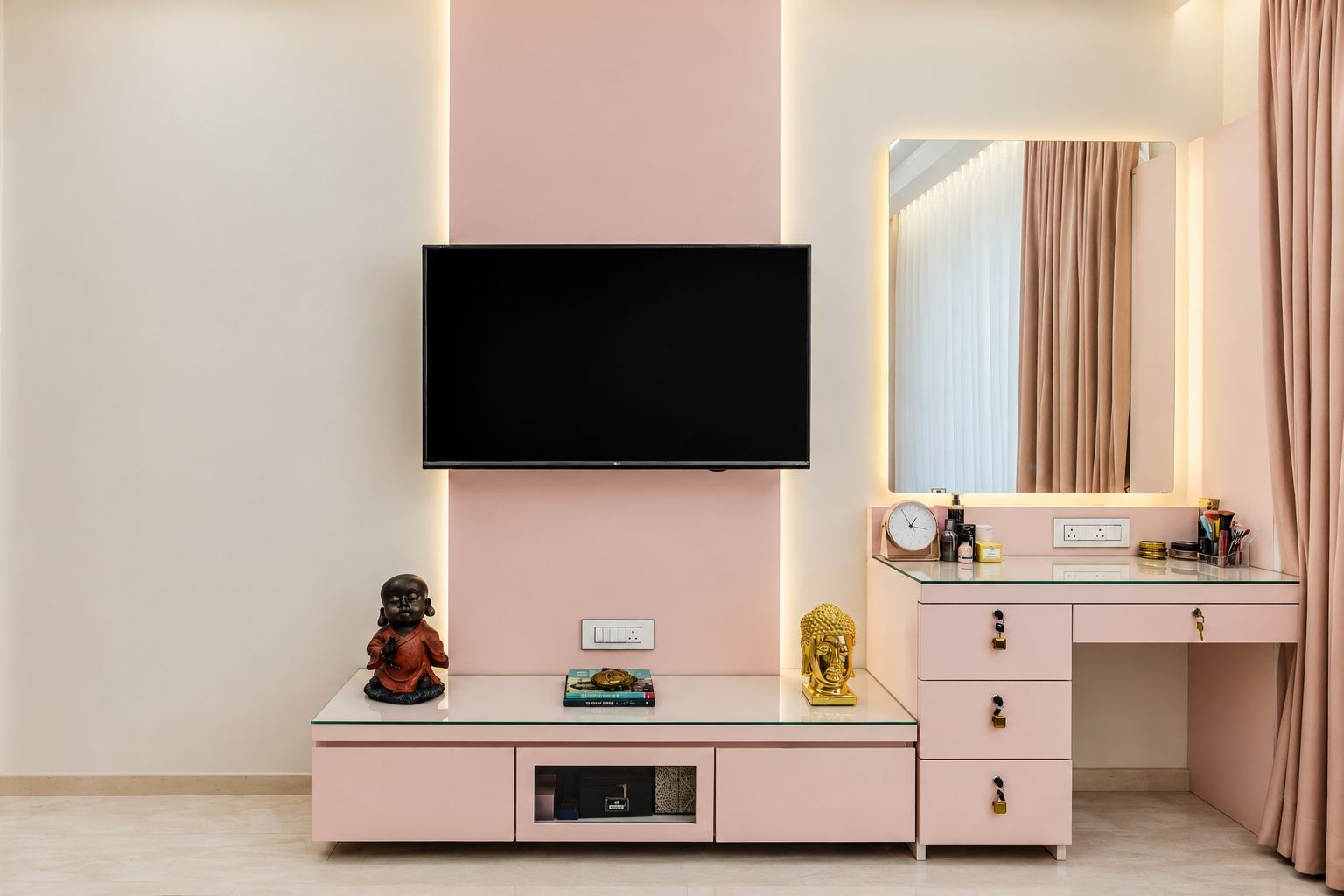 Pink media unit beside a dressing table with a backlit mirror