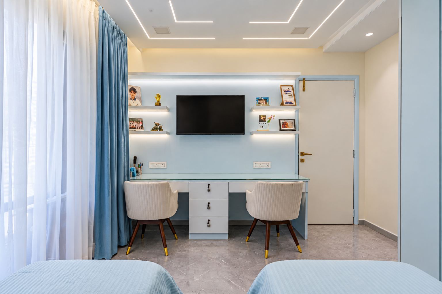 Powder-blue bedroom with a long shared desk for two