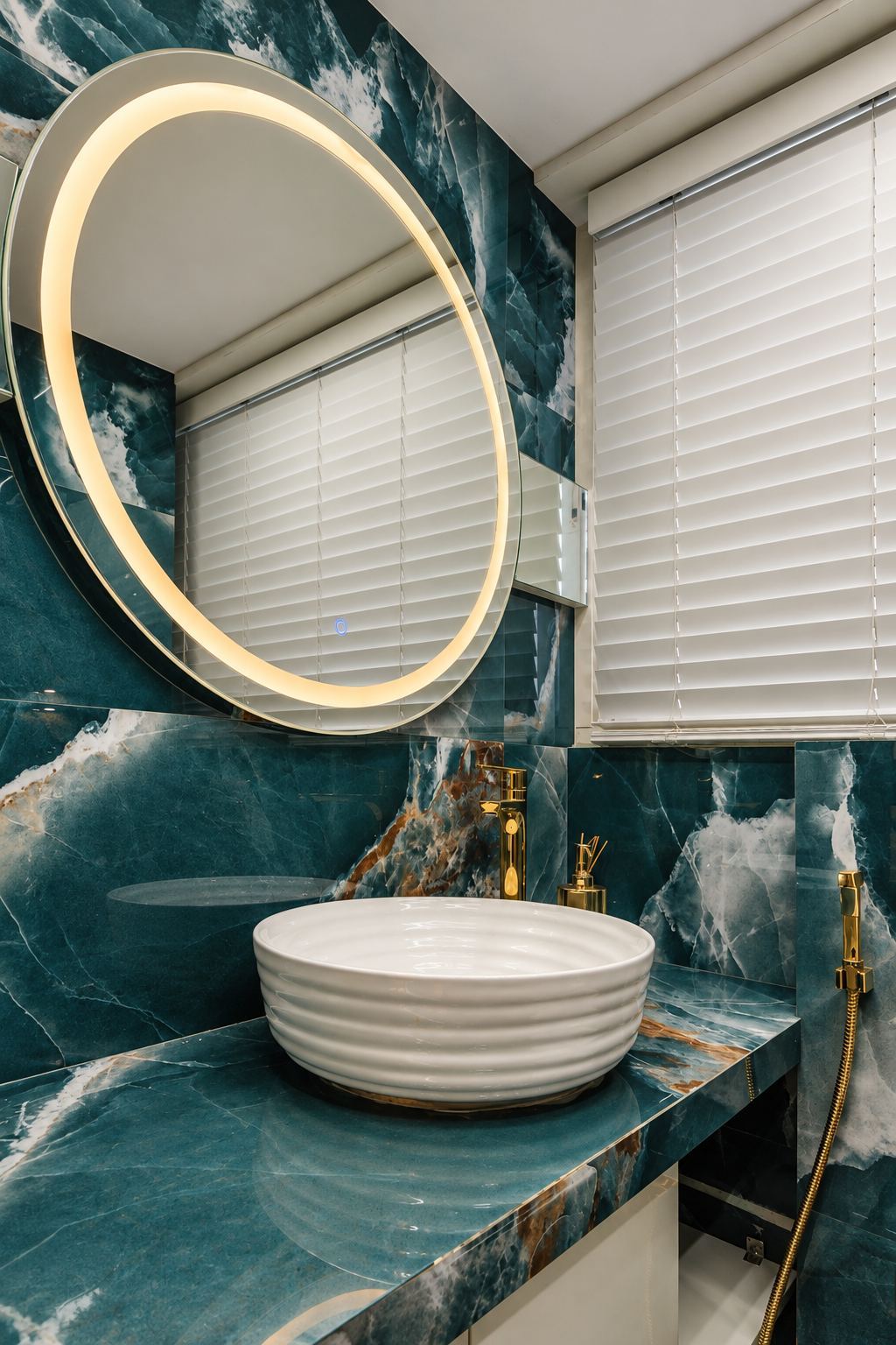 Ribbed vessel basin on teal marble under a round backlit mirror