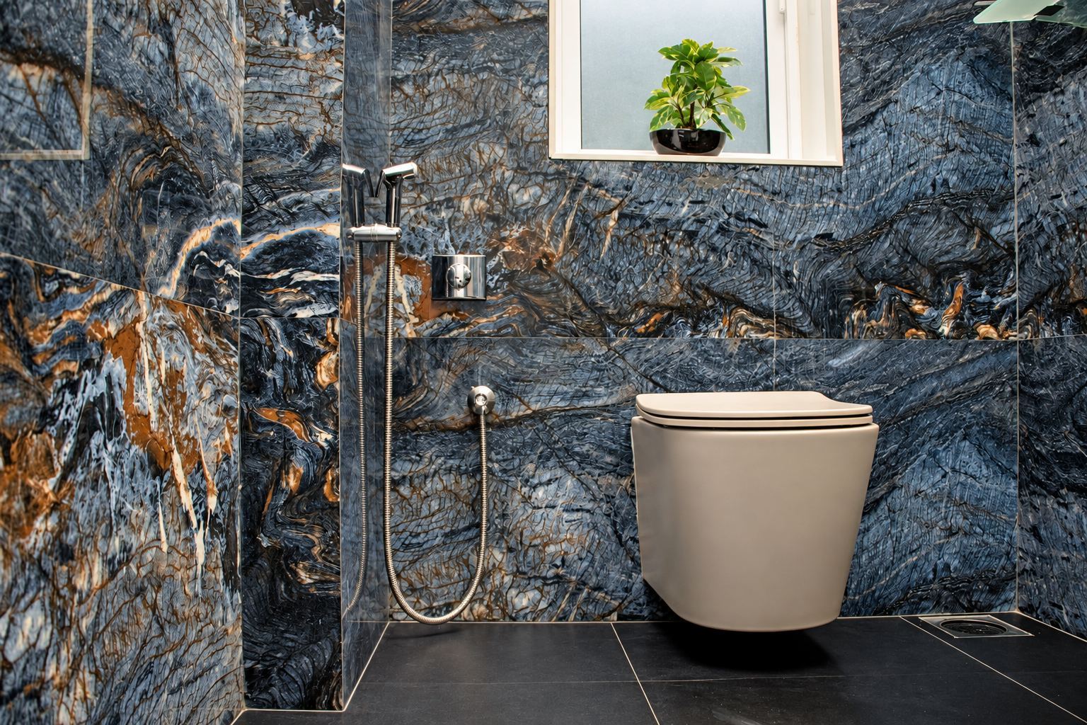 Bathroom in blue and rust veined stone with a wall-hung WC